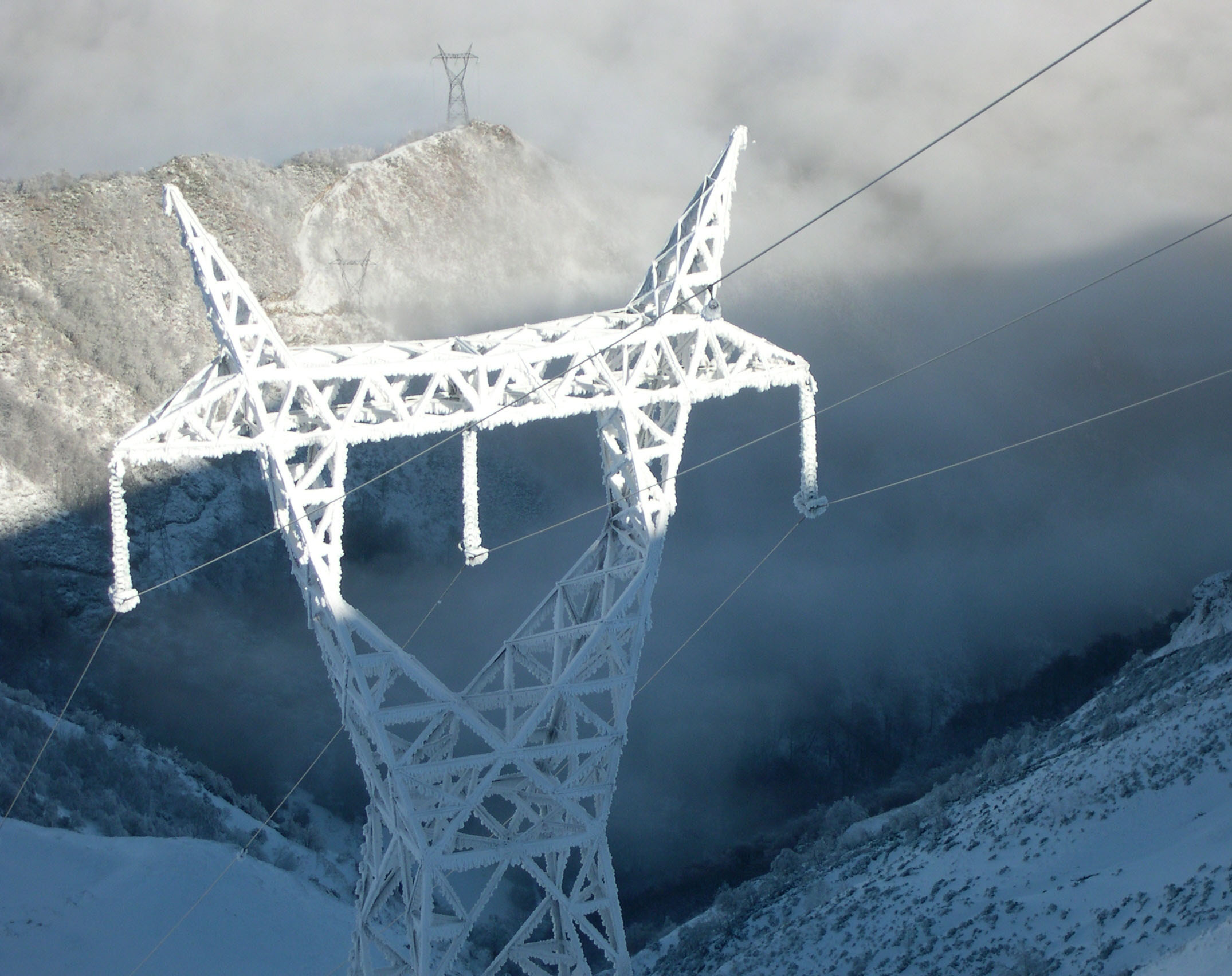 Snow-covered electricity tower alt