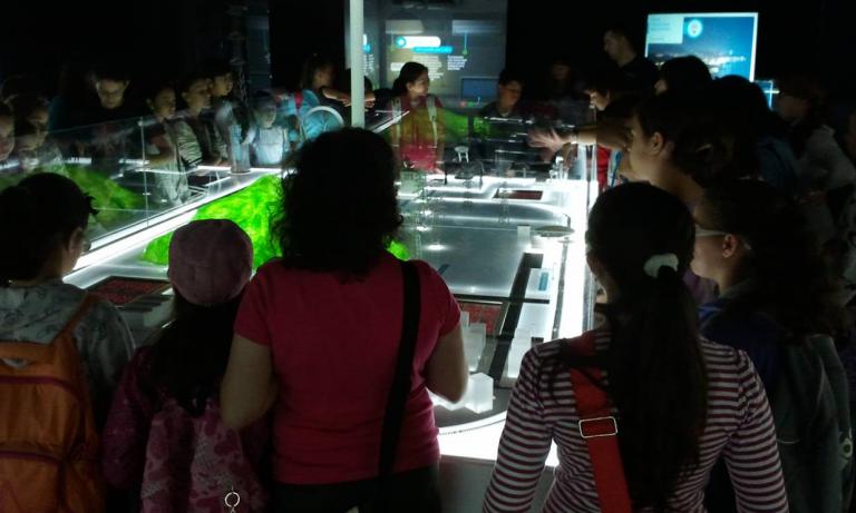 Students viewing the display model of the electricity system.