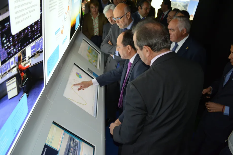 Officials in front of the demand curve module.